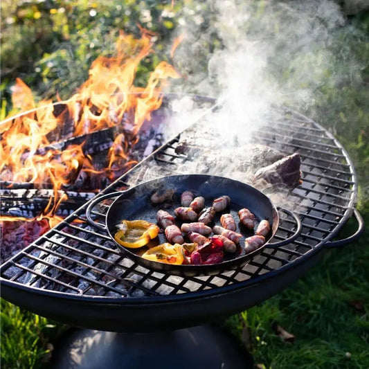 Firepits UK Half Moon Mesh BBQ Rack grilling over a fire pit