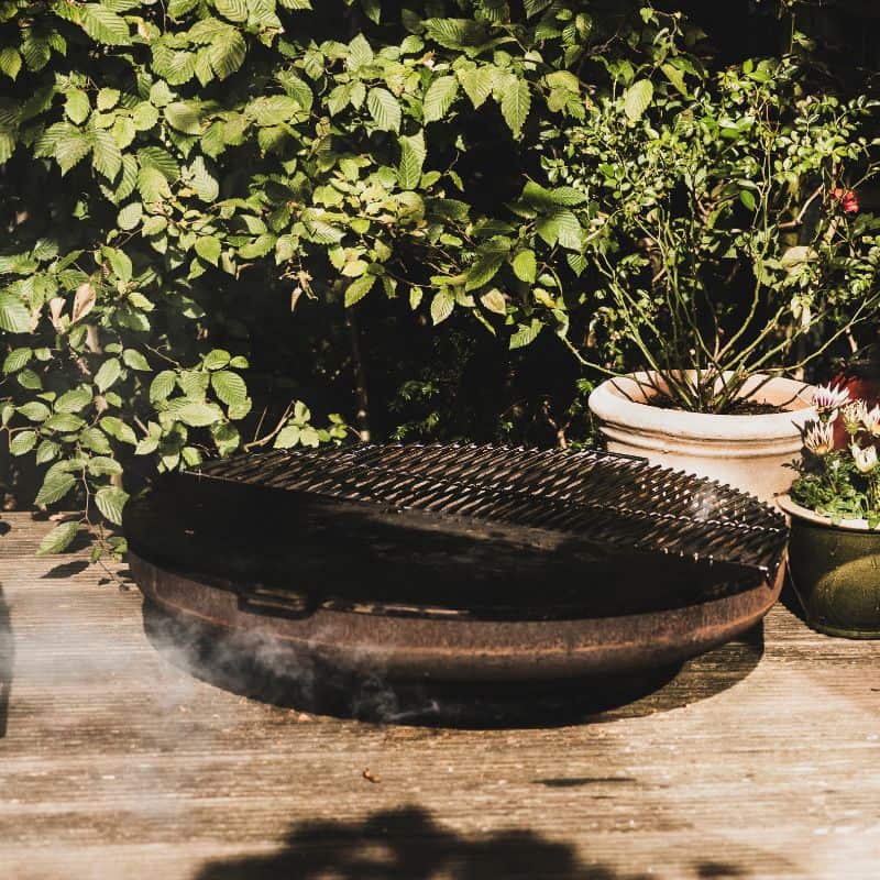 BonFeu Grill Half Circle on a BonBowl fire pit outdoors