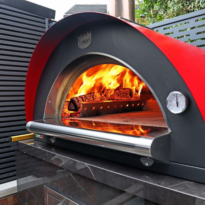 Clementi Original Wood Fired Pizza Oven in red, close-up with flames