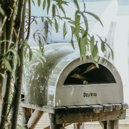 DeliVita Olive Green wood fired pizza oven, lifestyle shot 1