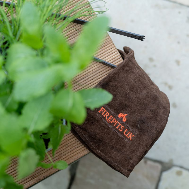 Firepits UK Fire Pit BBQ Gloves in brown on a table